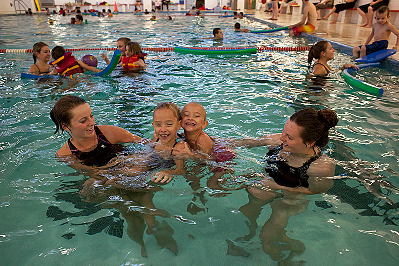Students and children enjoying the Acadia pool facility