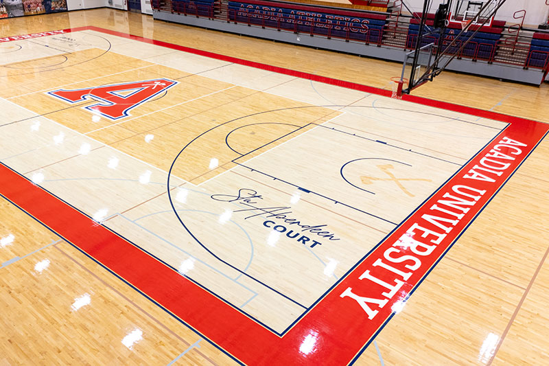 An oblique overhead view of the basketball court, which features a prominent Acadia 